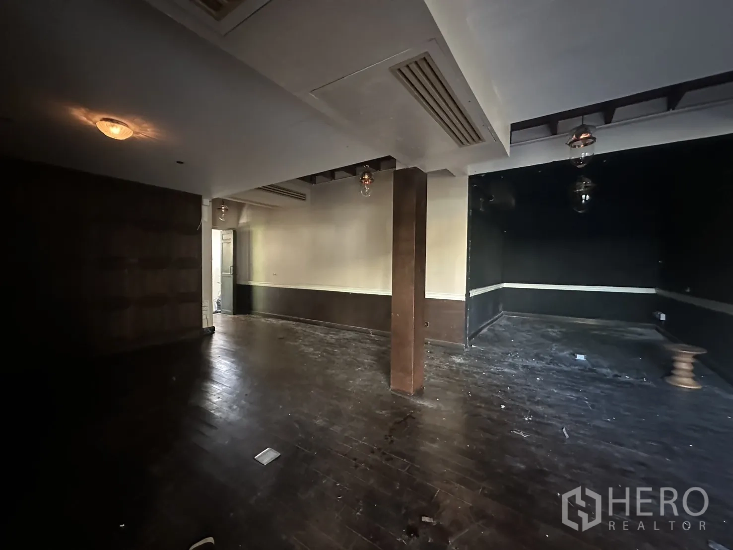 Detached House for rent - Dim interior room with built-in lighting and dark wood wall panels.