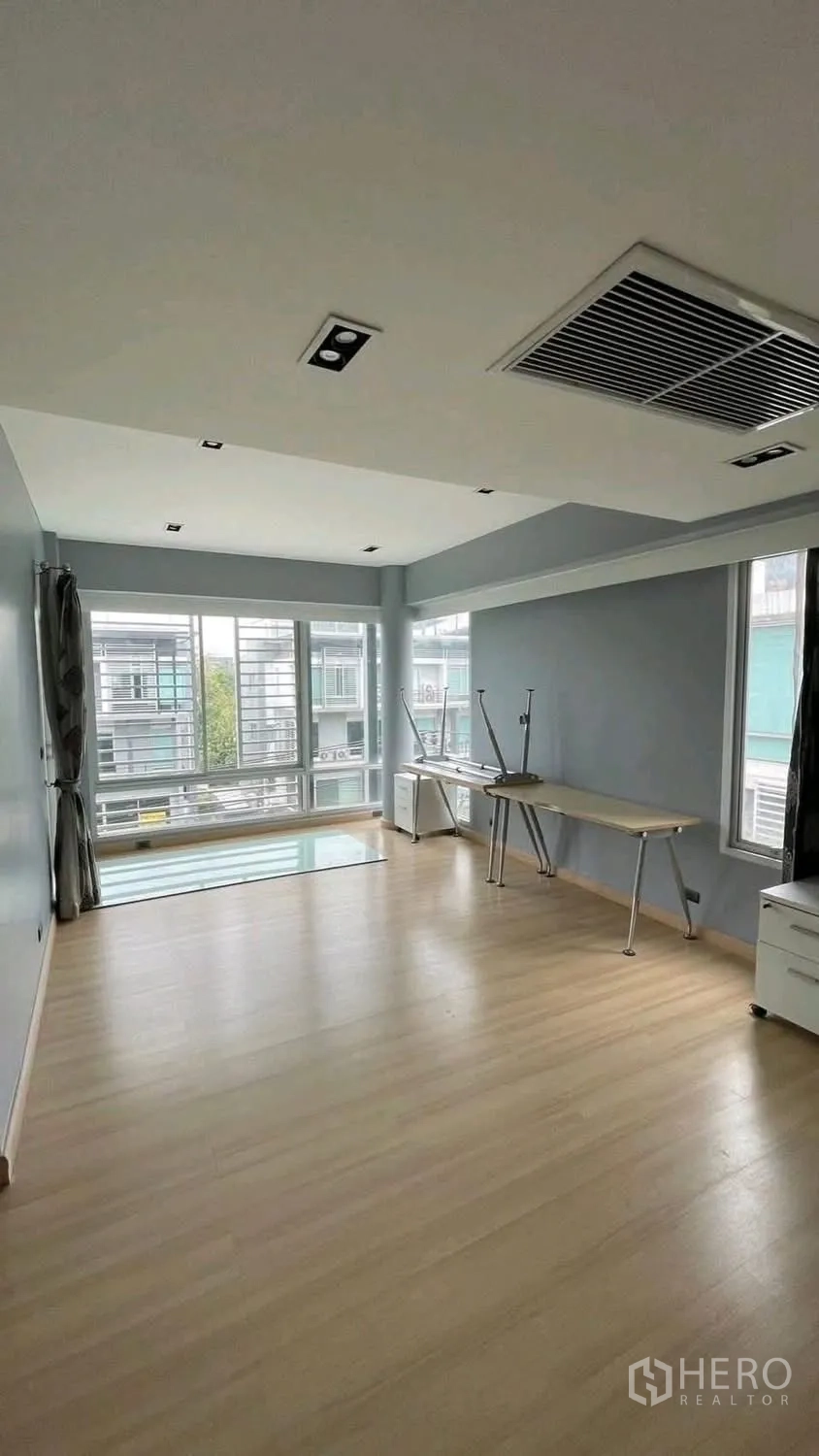 Home Office for rent or sale in Wang Thonglang, Bangkok - Large workspace with light wood floors, desks along the wall, and big windows.