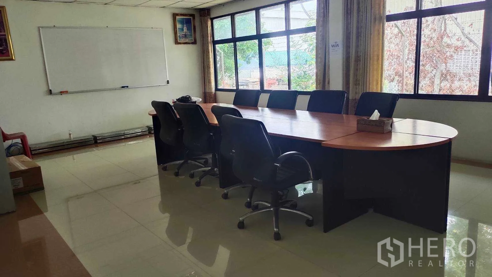 Factory for sale in Nikhom Phatthana, Rayong - Silver metal-clad warehouse exterior with roller shutter and truck-friendly yard.