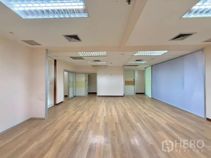 Office Space for rent in Chatuchak, Bangkok - Spacious open workspace with wood floor, ceiling vents and glass partitions.