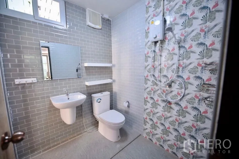 Detached House for rent in Bang Na, Bangkok - Updated bathroom with gray subway tiles, tropical accent wall and electric shower.