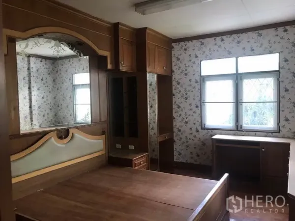 Detached House for rent in Sathon, Bangkok - Bedroom with built-in wooden wardrobes, dressing area and a large window.