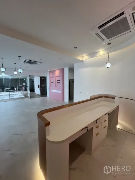 Retail Space for rent in Watthana, Bangkok - Curved built-in reception counter with overhead lighting in an open-plan retail area.