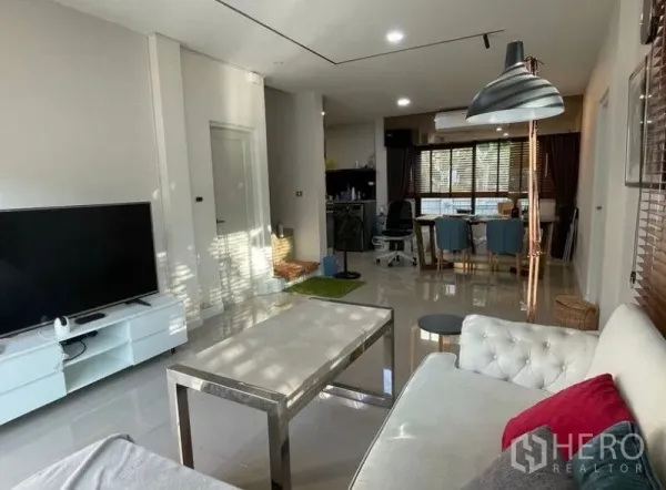 Detached House for rent - Open-plan living and dining area with tiled floors, white sofa, TV console, and modern lighting.