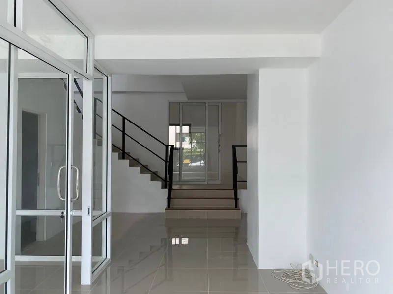 Home Office for rent in Wang Thonglang, Bangkok - Open lobby with glass walls leading to staircase and inner rooms.