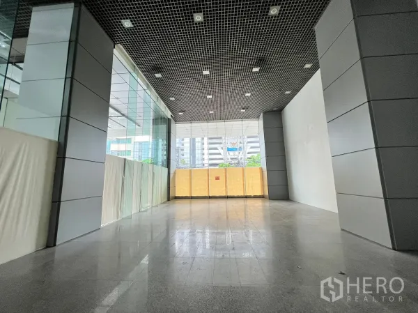 Retail Space for rent in Watthana, Bangkok - 151 sqm retail unit with floor-to-ceiling windows, metal-clad columns, and city views.
