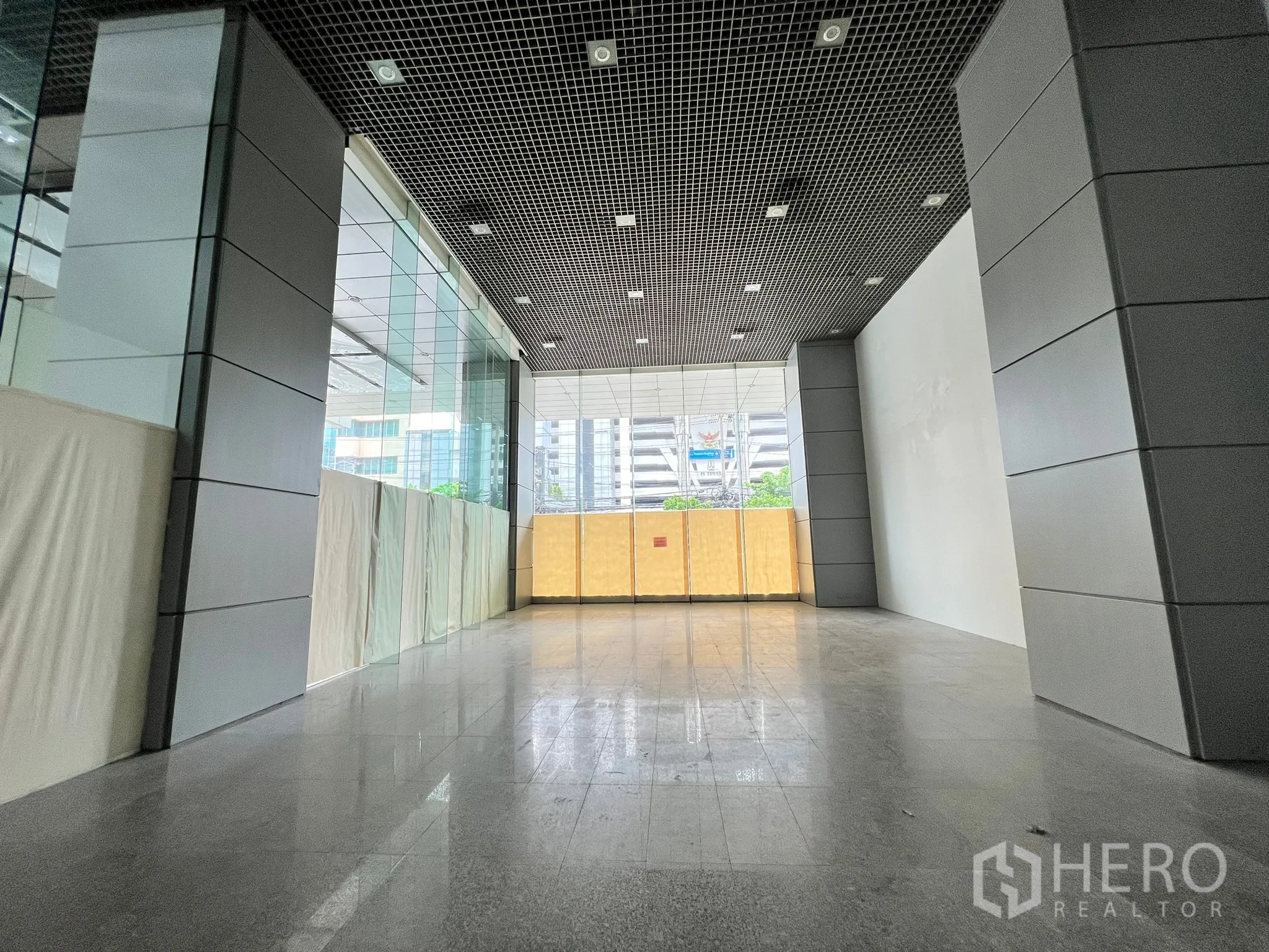Retail Space for rent in Watthana, Bangkok - 151 sqm retail unit with floor-to-ceiling windows, metal-clad columns, and city views.