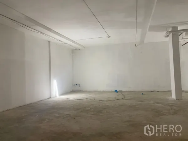 Retail Space for rent - Large blank retail space with concrete floor, white walls and utility points ready for fit‑out.