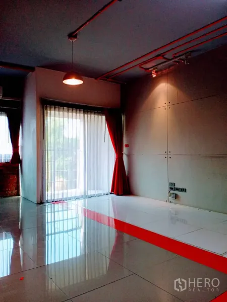Office Space for rent in Khlong Toei, Bangkok - Open office zone with glossy tiles, a raised white platform and sheer curtains by sliding glass doors.