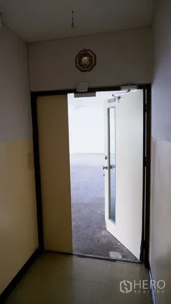 Office Space for rent in Watthana, Bangkok - Entrance corridor with an open door leading to a bright office space in Ekkamai, Watthana.