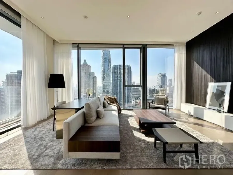 Condominium for rent or sale - Bright living room with floor-to-ceiling windows and panoramic Bangkok skyline views at Scope Lang Suan.