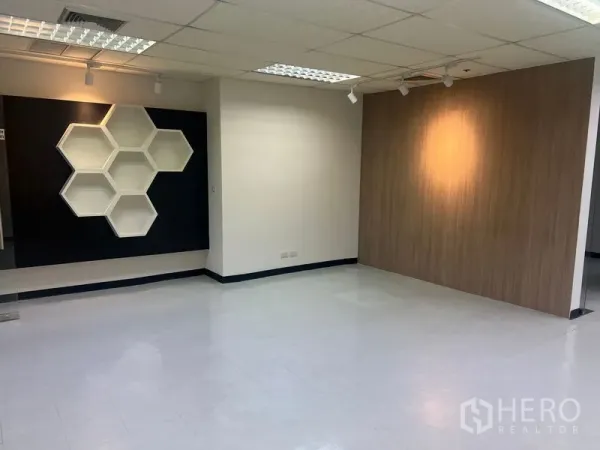 Office Space for rent in Watthana, Bangkok - Open-plan workspace featuring hexagonal wall shelves and spotlighting.