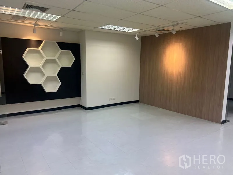 Office Space for rent in Watthana, Bangkok - Open-plan workspace featuring hexagonal wall shelves and spotlighting.