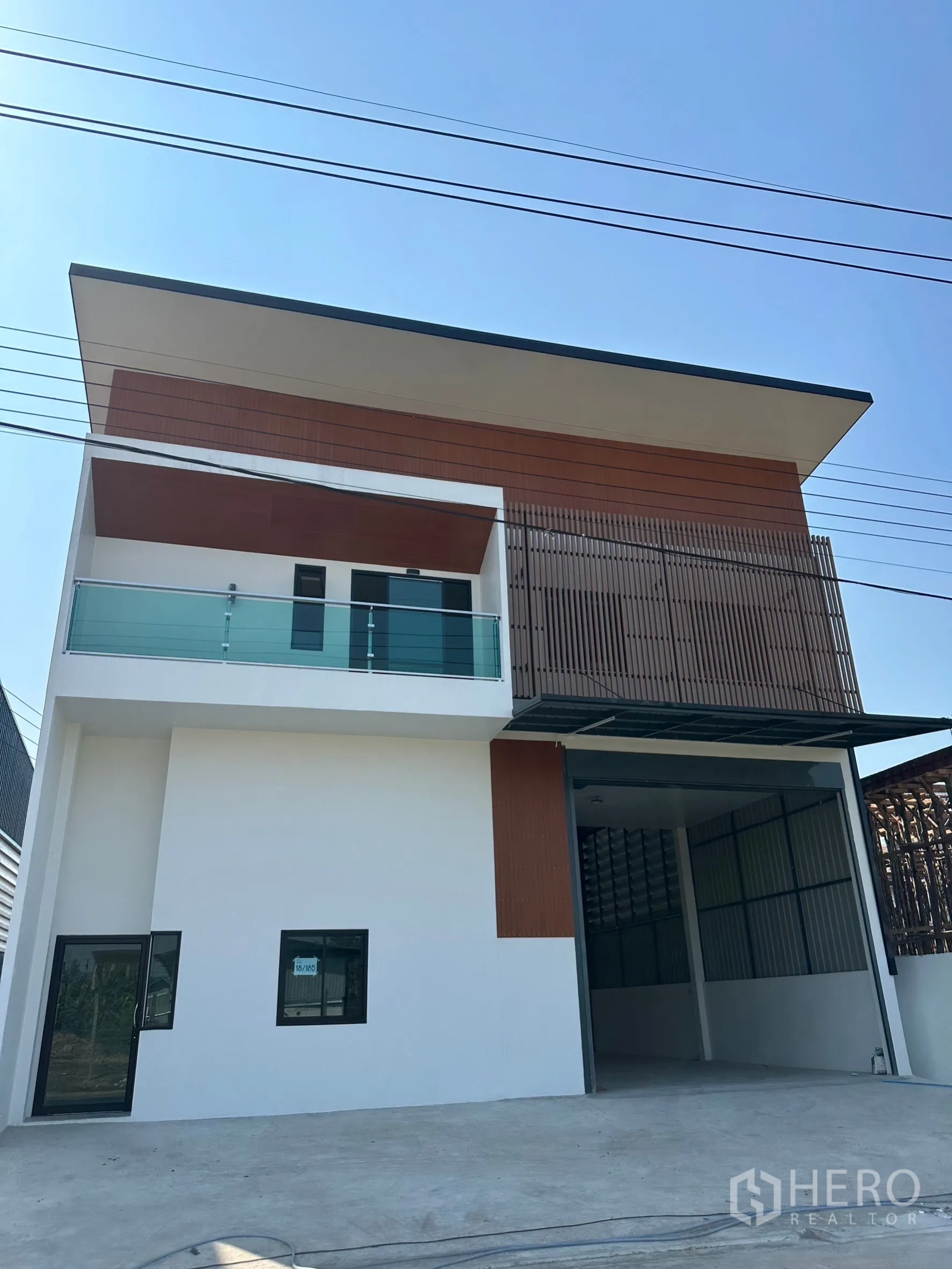 Warehouse for rent or sale - Front elevation showing balcony, slatted screen and a covered loading bay.