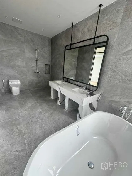 Home Office for rent or sale in Lat Phrao, Bangkok - Luxury bathroom with freestanding soaking tub, marble vanity and rain shower.