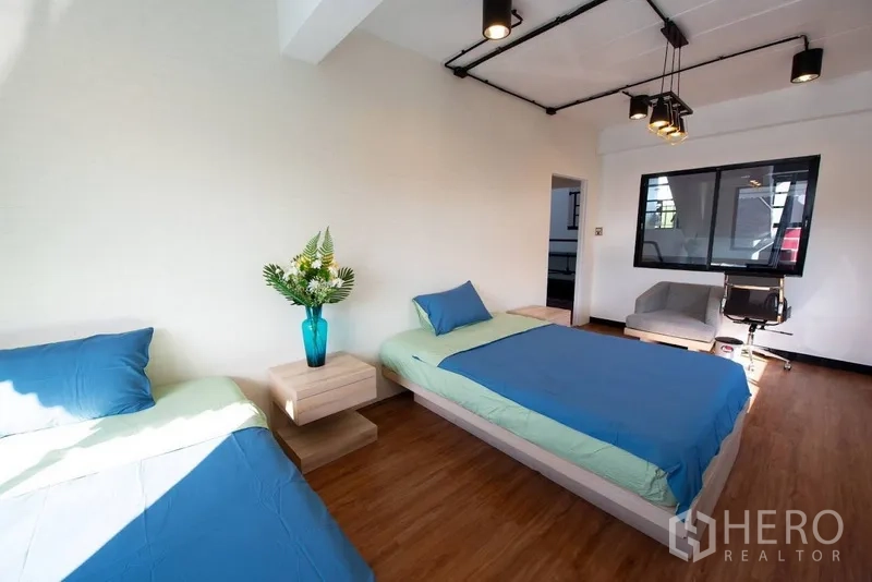Home Office for rent or sale in Phra Khanong, Bangkok - Bedroom with queen and single beds, desk chair and modern ceiling lights.