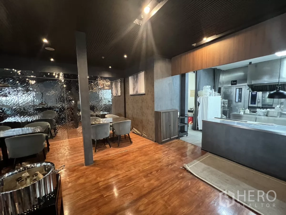 Retail Space for rent - Dining area beside an open professional kitchen with stainless counters.