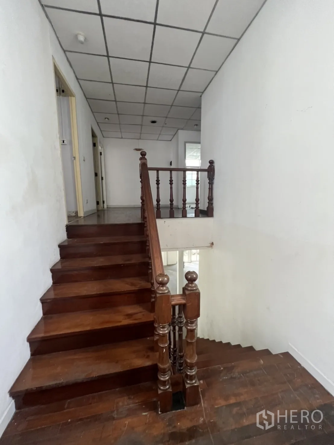 Detached House for rent or sale in Sathon, Bangkok - Classic wooden staircase with turned balustrade leading to upper floor.