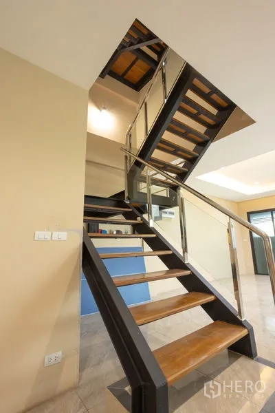 Home Office for rent in Bang Khen, Bangkok - Close-up of steel-and-wood staircase with glass and metal balustrade details.