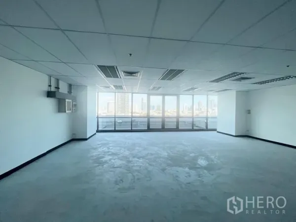 Office Space for rent in Watthana, Bangkok - Office corner with wall-to-wall windows offering Bangkok city skyline views.