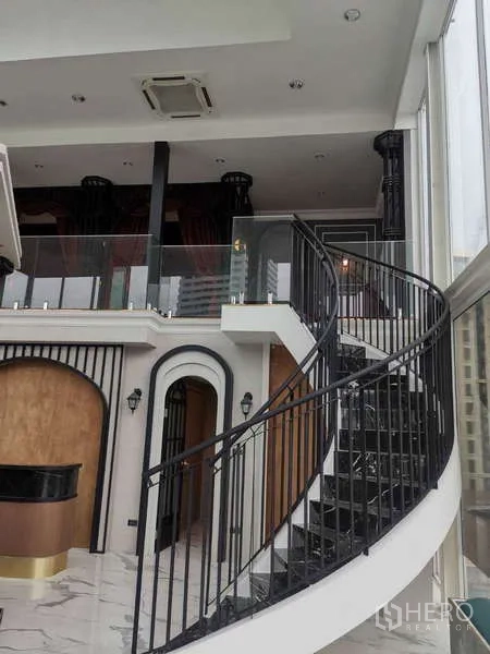 Retail Space for rent - Mezzanine level with glass railing above built-in shelves.