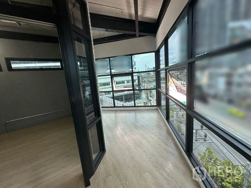 Office Space for rent in Chatuchak, Bangkok - Corner workspace with wraparound glass walls providing city street views.