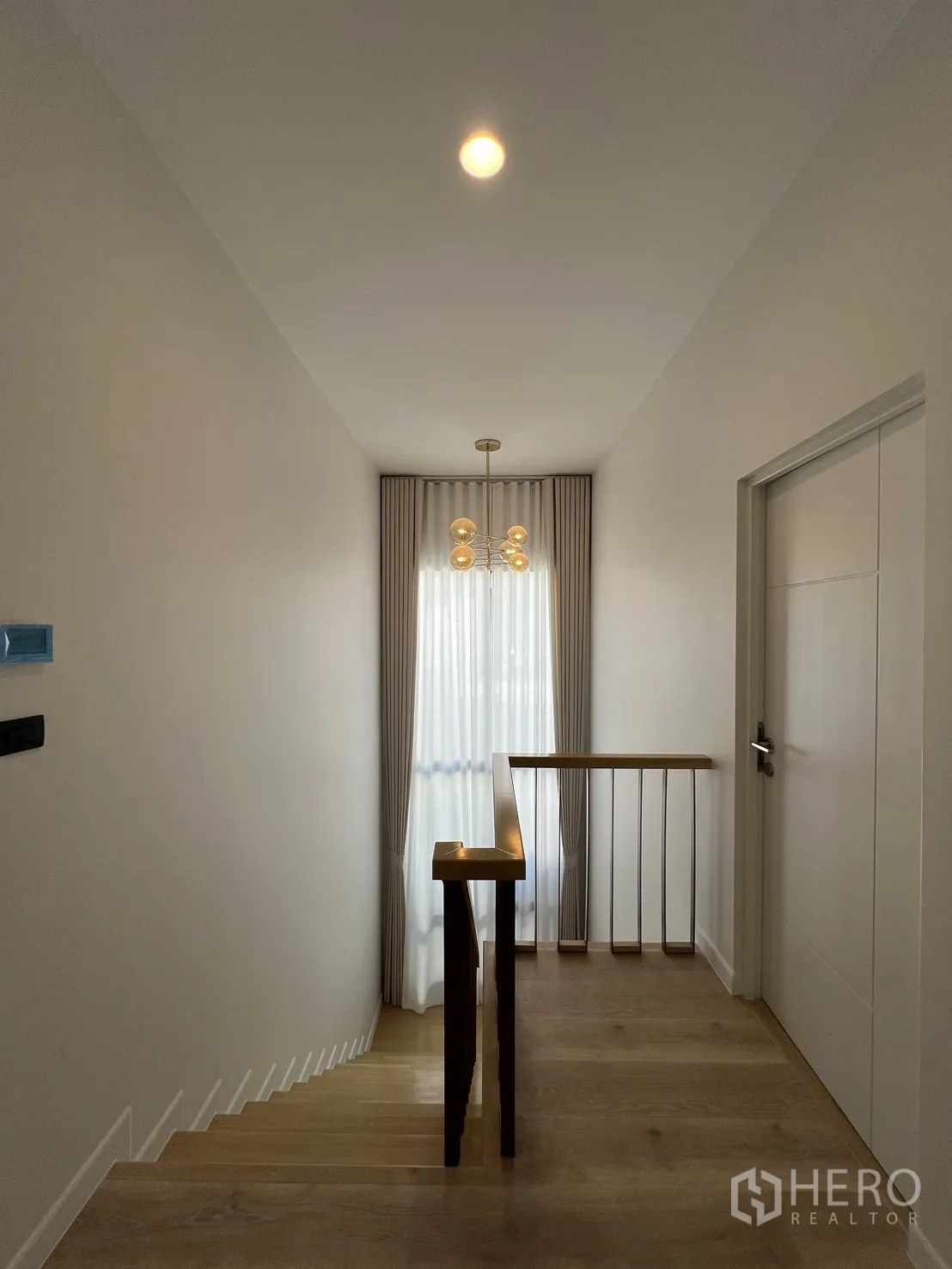 Detached House for rent or sale in Bang Kapi, Bangkok - Third bedroom with soft grey curtains, double bed and corner windows.