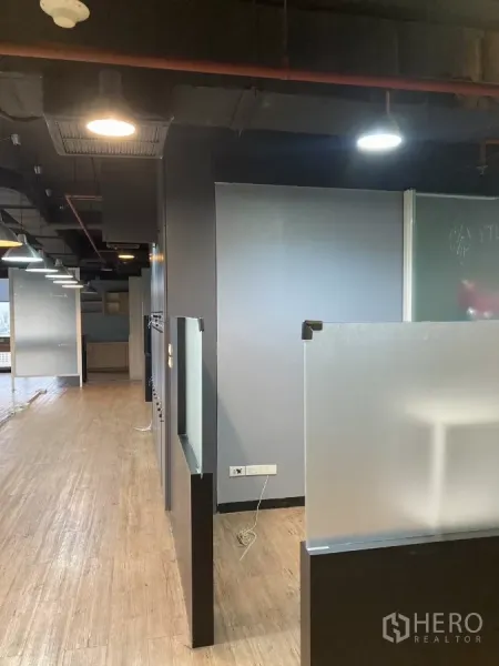 Office Space for rent in Watthana, Bangkok - Office corridor with frosted dividers, exposed ceiling and wooden floors in Watthana, Bangkok.