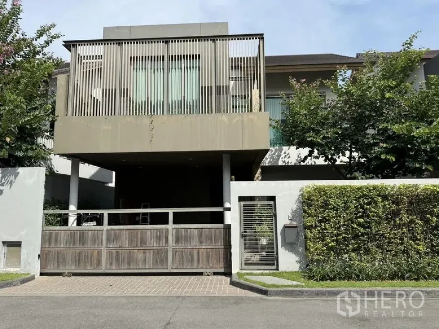 Detached House for rent or sale in Bang Kapi, Bangkok - Modern two-storey detached house exterior with gated carport and landscaping.