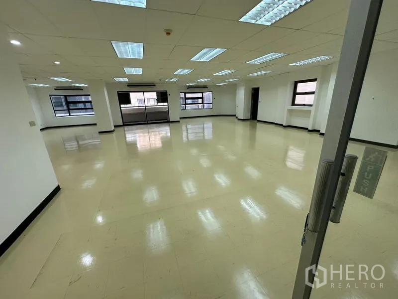 สำนักงาน ให้เช่าในPathum Wan, Bangkok - มุมมองจากประตูกระจกเข้าสู่พื้นที่สำนักงานแบบเปิด เพดานตารางและหน้าต่างหลายบาน