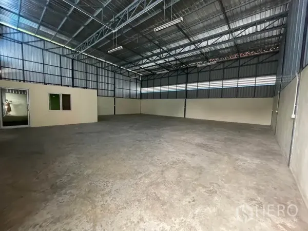 Warehouse for rent in Khlong Luang, Pathum Thani - High-ceiling warehouse interior with steel trusses and smooth concrete floor.
