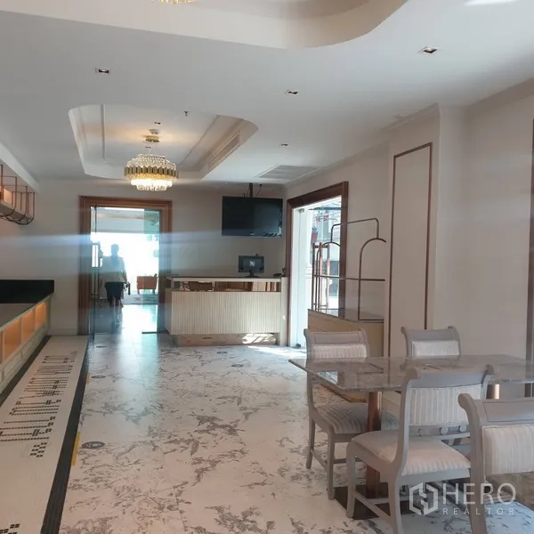 Retail Space for rent in Khlong Toei, Bangkok - Spacious dining room with marble-look flooring, reception counter, and crystal chandelier lighting.
