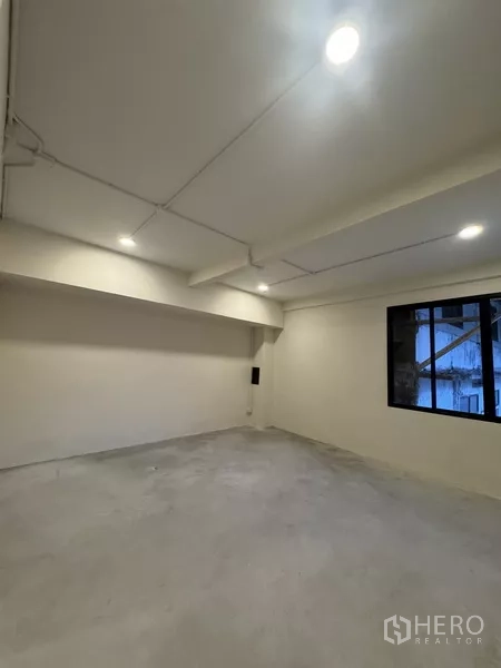 Shophouse for rent - Partitioned office area featuring black‑framed internal windows and a doorway.