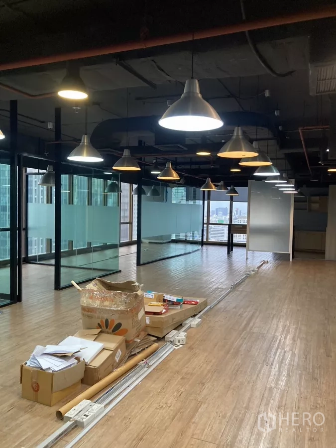 Office Space for rent in Watthana, Bangkok - Large open-plan office with hanging lights, glass rooms and skyline outlook in Watthana.