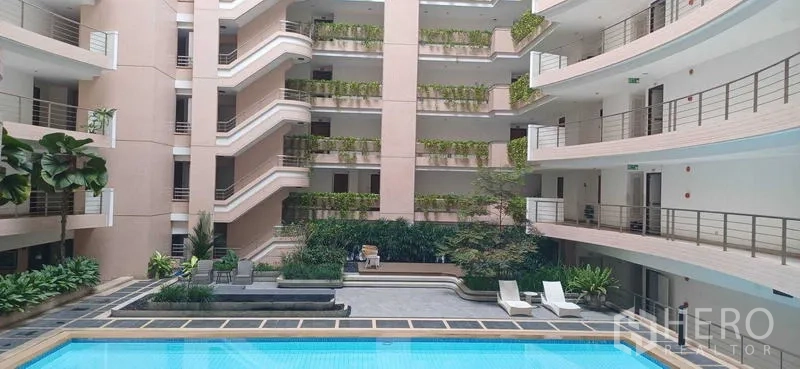 Condominium for sale in Pathum Wan, Bangkok - Central atrium swimming pool surrounded by balconies and landscaped greenery.