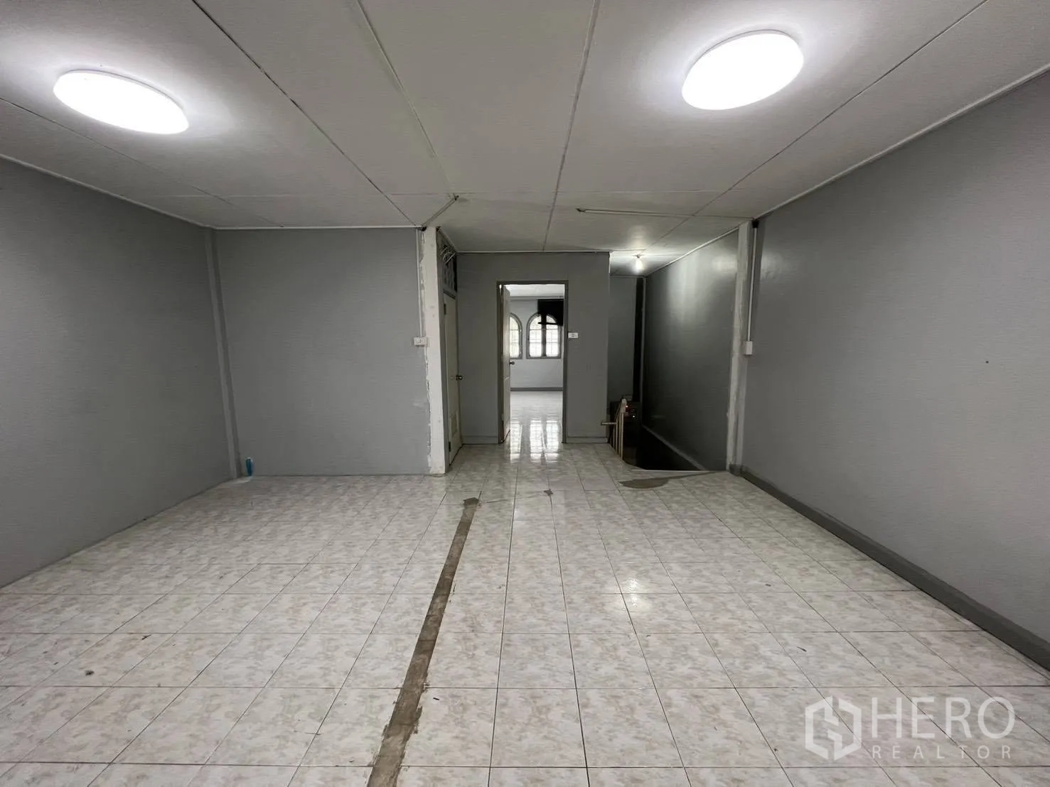 Townhouse for rent in Watthana, Bangkok - Large open hall with staircase access and tiled floor.
