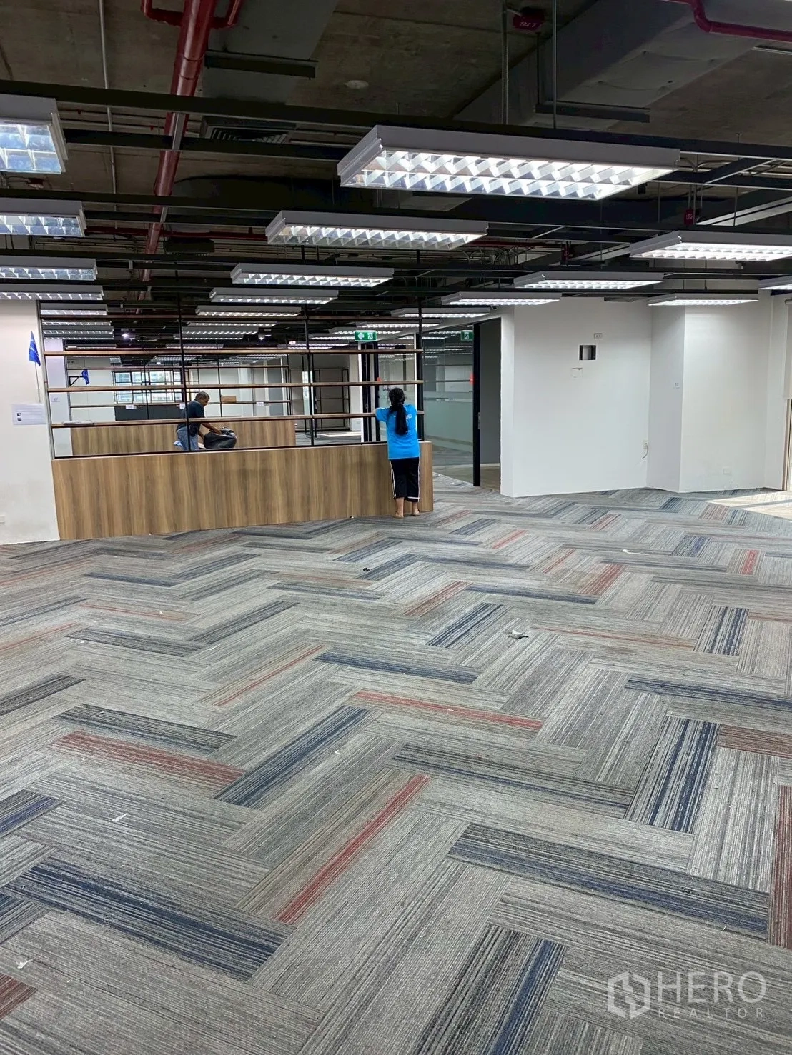 Office Space for rent in Watthana, Bangkok - Reception counter and metal shelving dividing the open-plan office.