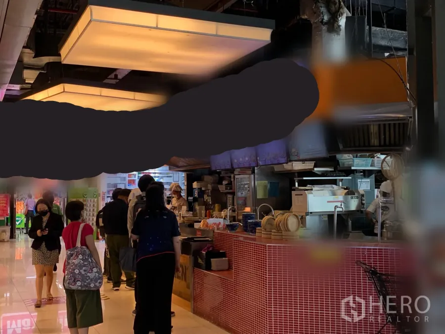 Retail Space for rent in Khlong Toei, Bangkok - Indoor mall retail unit with a red-tiled service counter, bright ceiling lights, and kitchen equipment, ideal for food and beverage near BTS Ekkamai.