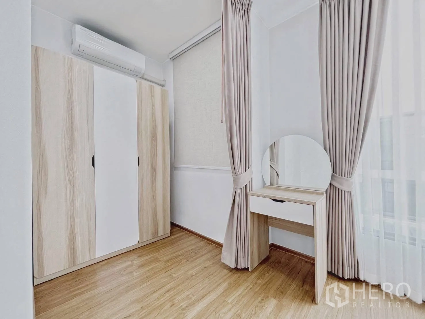 Townhouse for rent in Bang Phli, Samut Prakan - Wardrobe and dressing table set beside tall curtained windows.