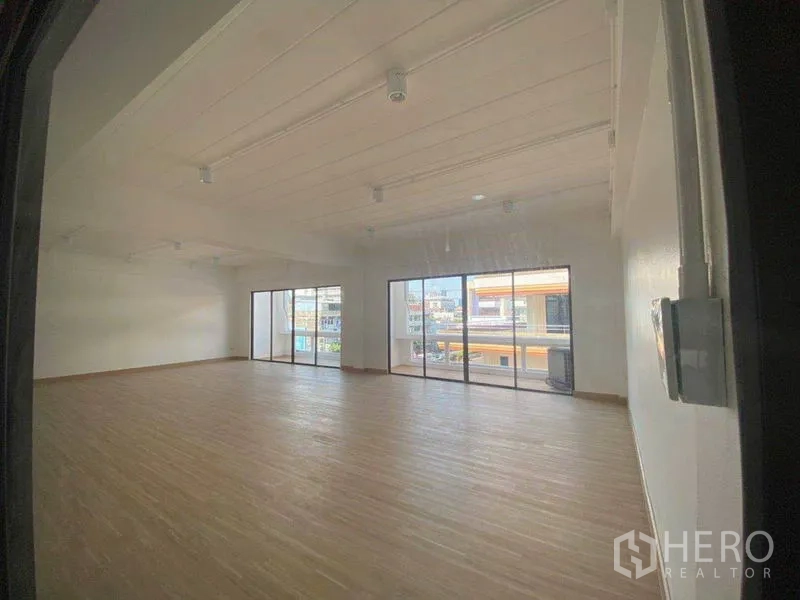 Office Space for rent in Watthana, Bangkok - Open workspace viewed from the entry, featuring floor-to-ceiling glass and city outlook.