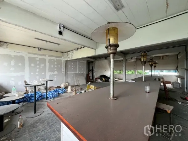 Retail Space for rent in Watthana, Bangkok - Close-up of countertop with vintage-style lamps and patch-ready walls inside the space.