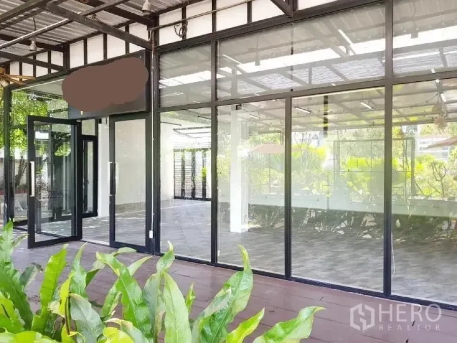 Office Space for rent in Chatuchak, Bangkok - Glass-front office exterior with sliding doors and a covered terrace facing greenery in Chatuchak, Bangkok.