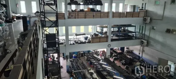Warehouse for rent or sale in Bang Phli, Samut Prakan - Multi-level warehouse interior showing open production floor and a central cargo lift shaft.