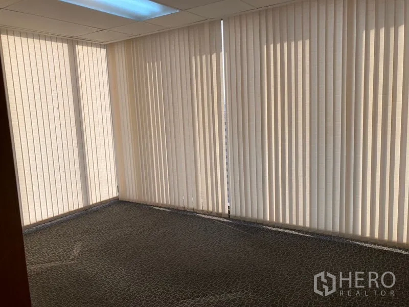 Office Space for rent - Small meeting room with full-height windows covered by vertical blinds and carpet flooring.