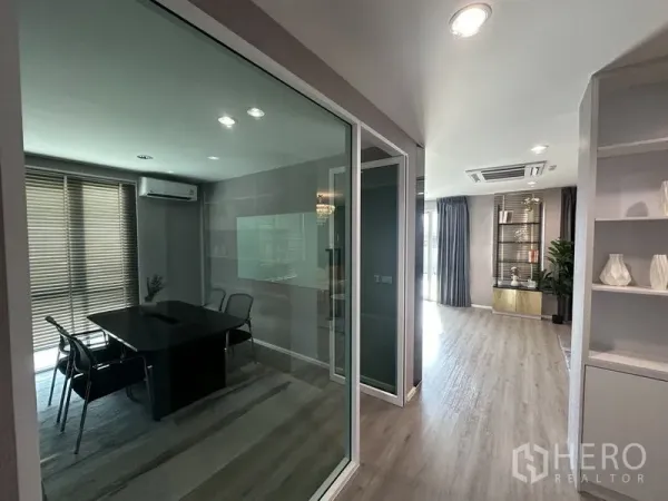 Factory for sale in Lam Luk Ka, Pathum Thani - Glass-walled meeting room next to a corridor with light wood flooring.