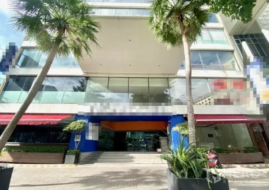 Retail Space for rent in Pathum Wan, Bangkok - Modern commercial building facade with palm trees and a wide pedestrian walkway.