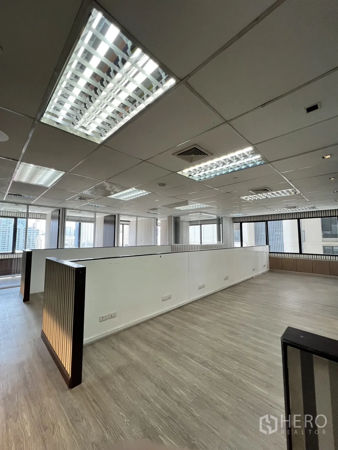 Office Space for rent in Watthana, Bangkok - Open-plan workspace with windows, fluorescent lighting, and vinyl floors.