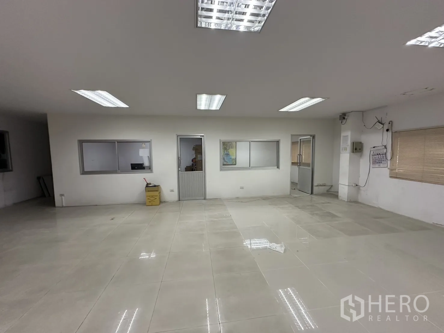 Factory for rent - Manager’s room with internal windows and door to adjoining offices.