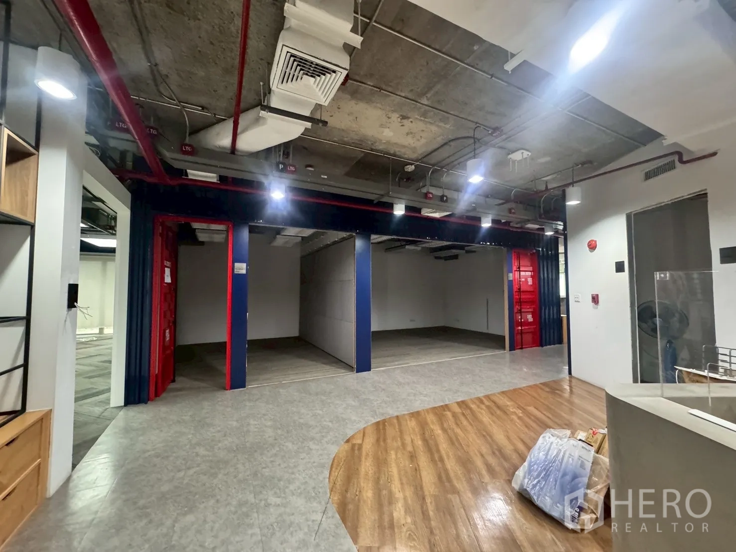 Office Space for rent in Watthana, Bangkok - Open bays with partitioned rooms and exposed industrial ceiling.