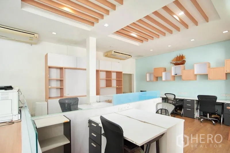 Home Office for rent in Wang Thonglang, Bangkok - Large office area with multiple workstations and decorative wood-slat ceiling.